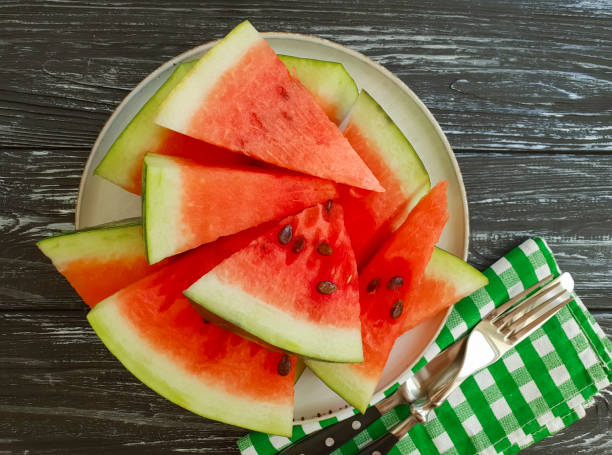 istock watermelon slices on a black wooden background 1028421224