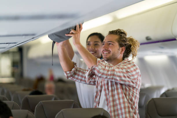 260+ Flight Attendant Helping With Luggage Stock Photos, Pictures ...