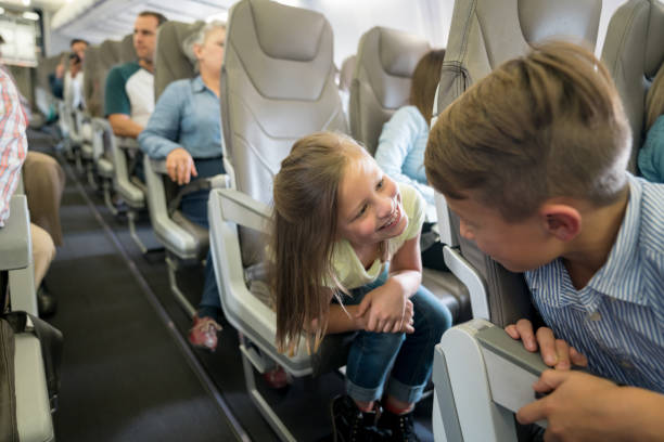 istock Happy kids traveling by plane 1028421492