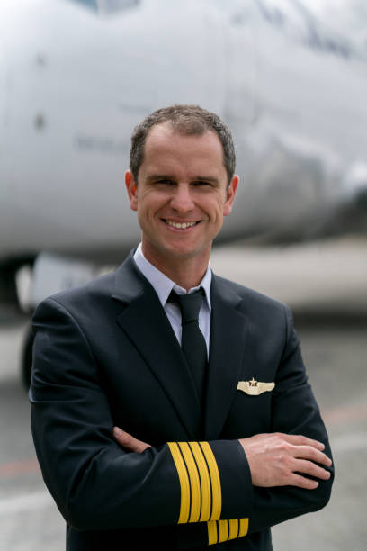 istock Portrait of a successful pilot next to a plane 1028421526