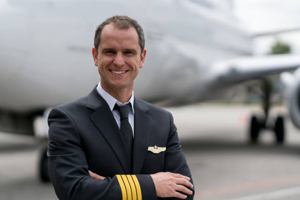 istock Portrait of a successful pilot next to an airplane 1028421534