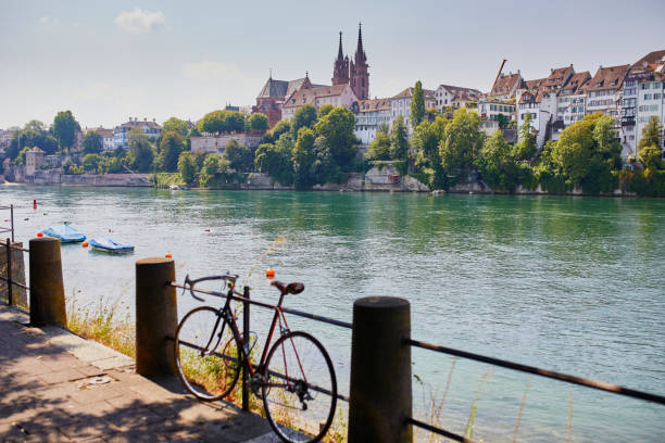 View of Rhine embankment in Basel, Switzerland Scenic view of Rhine embankment with people swimming in the river in Basel, Switzerland rhine river photos stock pictures, royalty-free photos & images