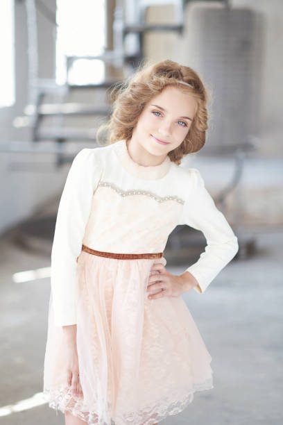 istock Happy little girl model with charming smile posing in a studio. 1028427608