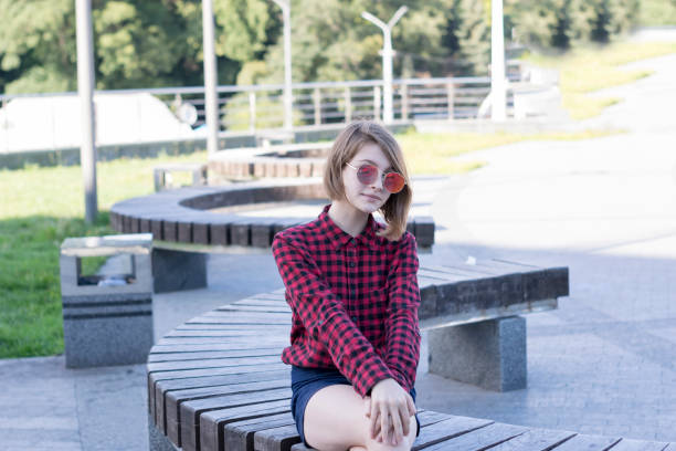 istock Attractive lady resting outdoors in park 1028430066