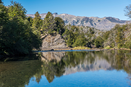 Reflection on a mountain river at San Martin de los Andes, Argentina.