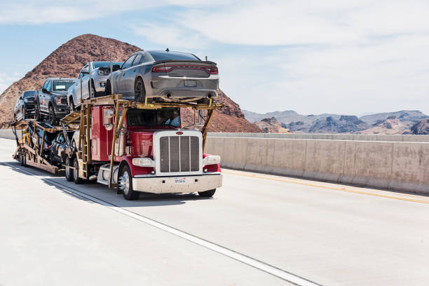 Car Transporter Car carrier on the Mike O'Callaghan–Pat Tillman Memorial Bridge. This bridge is bypass highway at Hoover Dam. car transporter photos stock pictures, royalty-free photos & images