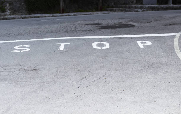 istock Stop Marking Text on the Asphalt Road 1028435042