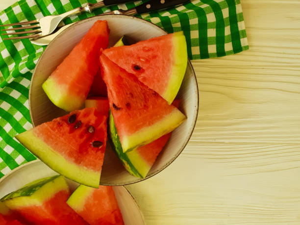 istock watermelon slices on a white wooden background 1028436044