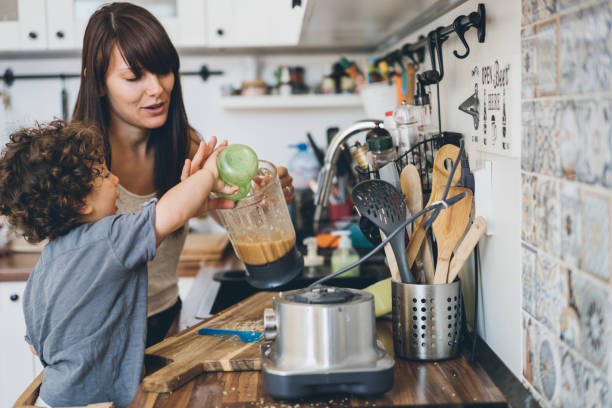 istock Mother and her little son preparing healthy smoothie 1028440114