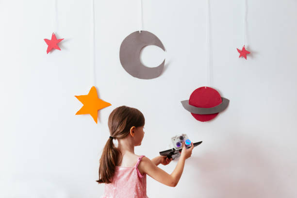 istock kid pretending to be an astronaut 1028449850
