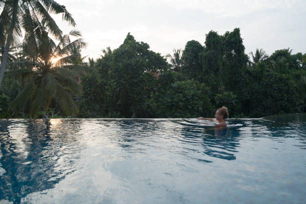 istock Young woman swimming in infinity pool, Ubud, Bali 1028452596