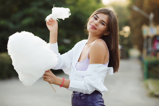 istock Girl eating cotton candy 1028457538