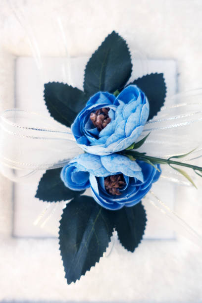 istock Gift with ribbons and beautiful blue flowers bouquet 1028459762