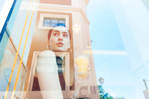 istock reflection through a bar window of a woman 1028462586