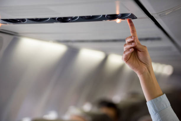 People traveling by air and calling an air hostess in the airplane â travel concepts