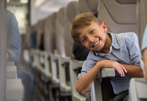istock Happy boy traveling by plane 1028463128