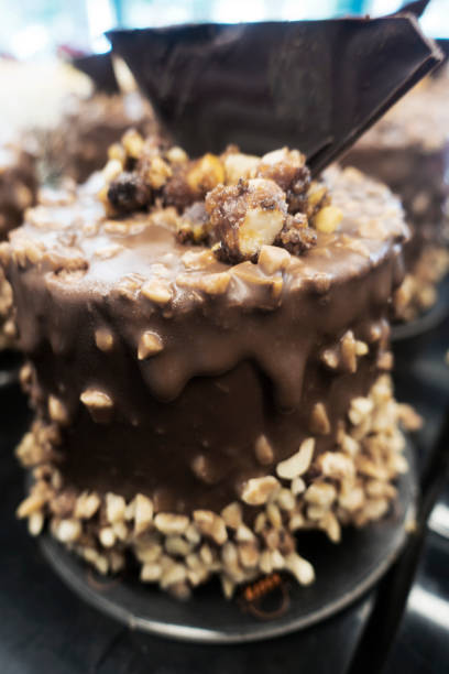 istock Close-up Chocolate cake with nuts on pink background 1028463132