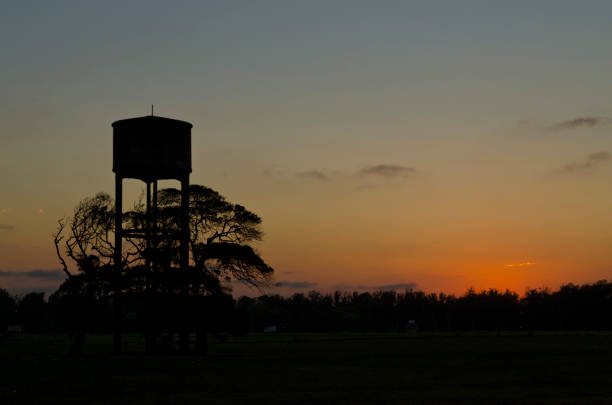 istock dusk in the field with shaded water tank 1028465904