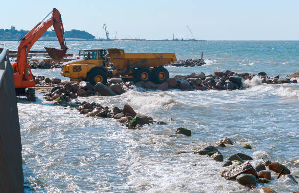 istock coastal protection measures, construction equipment on the shore, the construction of breakwaters 1028471484