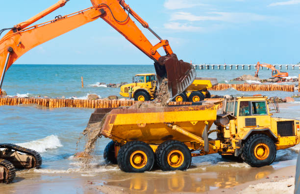 istock coastal protection measures, construction equipment on the shore, the construction of breakwaters 1028471546