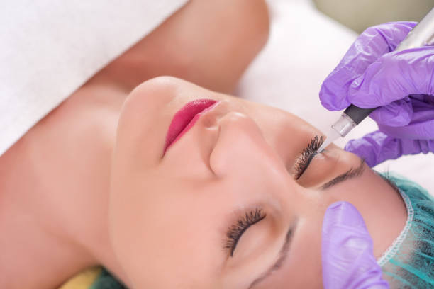 istock Cosmetologist applying permanent makeup on eyes 1028474616