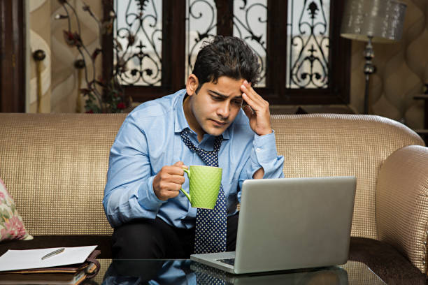 istock Latin descent man using laptop computer. Home setting. Morning coffee. - Stock image 1028474776