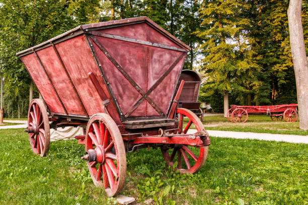 A Red Chuck Wagons in the Garden of Wilanow Park A Red Chuck Wagons in the Garden of Wilanow Park chuck wagon stock pictures, royalty-free photos & images