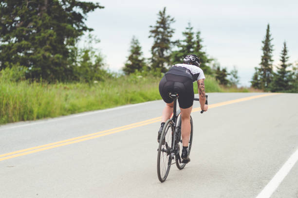 istock Cyclist rides along a rural highway 1028477598