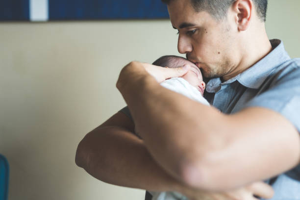 istock New dad holds his infant daughter 1028477968