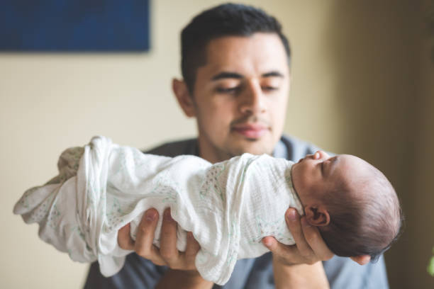 istock New dad holds his infant daughter 1028477972