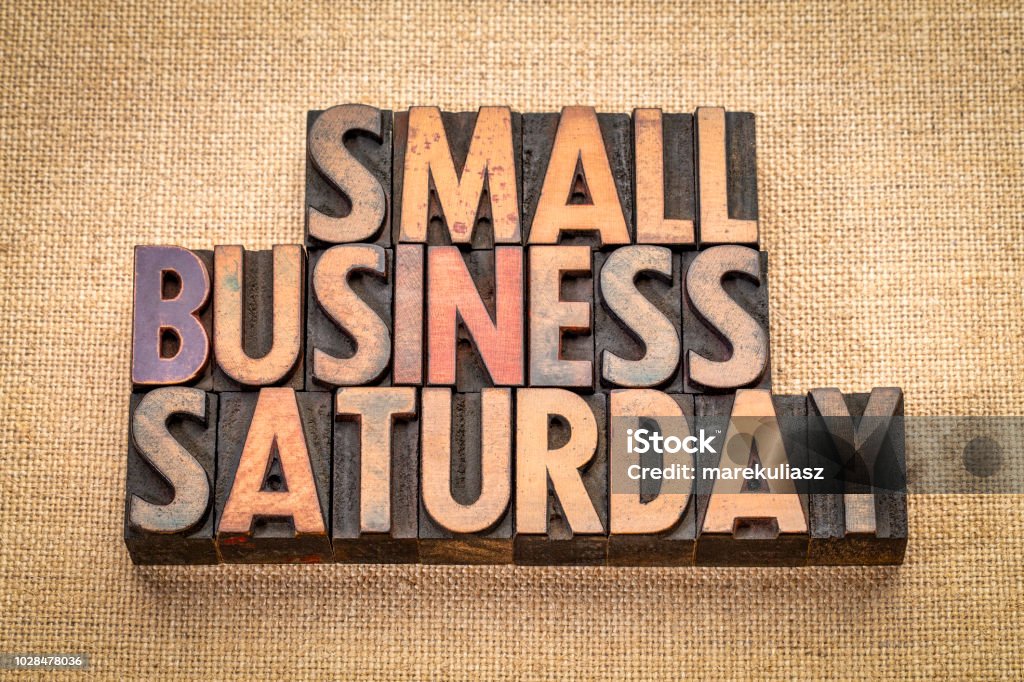 Small Business Saturday in wood type Small Business Saturday word abstract - text in vintage letterpress wood type against burlap canvas, holiday shopping concept Small Business Stock Photo