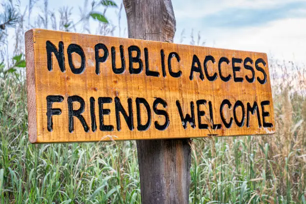 no public access, friends welcome - wooden sign in forest