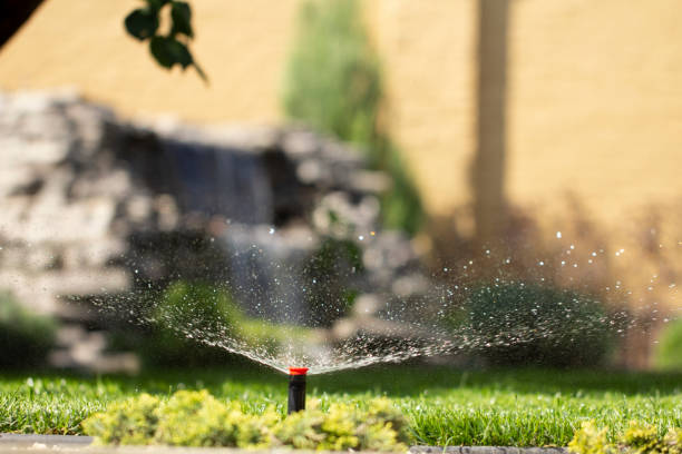 istock automatic sprinkler system watering the lawn on a background of green grass 1028486784