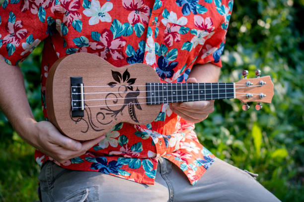 istock man with hawaiian shirt and ukulele 1028486848