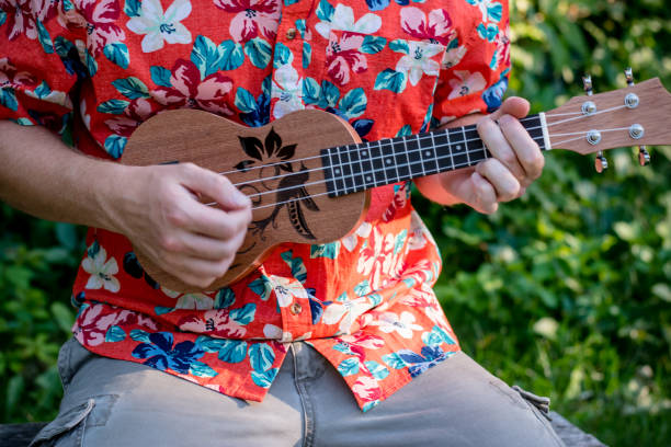 istock man with hawaiian shirt and ukulele 1028486850