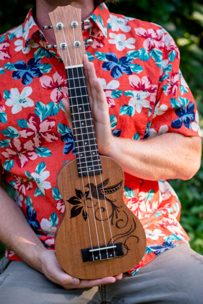 istock man with hawaiian shirt and ukulele 1028486856