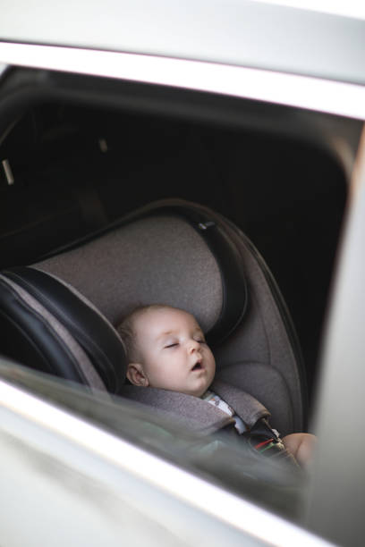 istock Baby sleeping in car safety seat while 1028489540