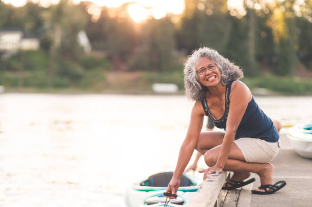 istock A beautiful older woman prepares to go kayaking 1028489828