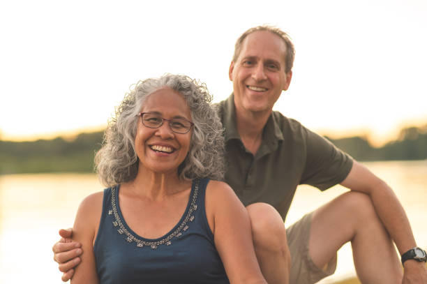 istock Interracial senior couple sit on the dock on a summer evening 1028489832
