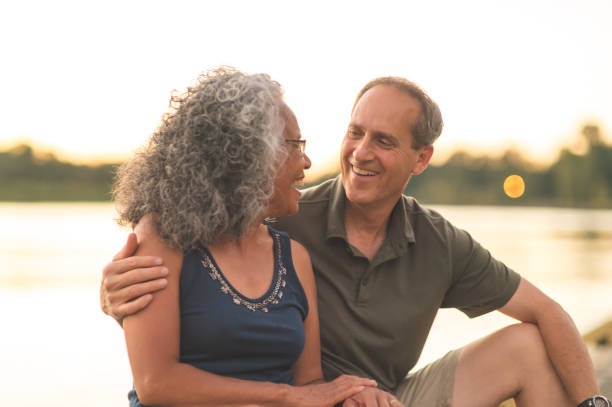 istock Interracial senior couple sit on the dock on a summer evening 1028489836
