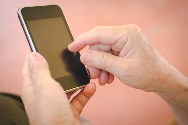istock woman holding mobile phone. hand texting message, using app with smartphone outdoor 1028504526