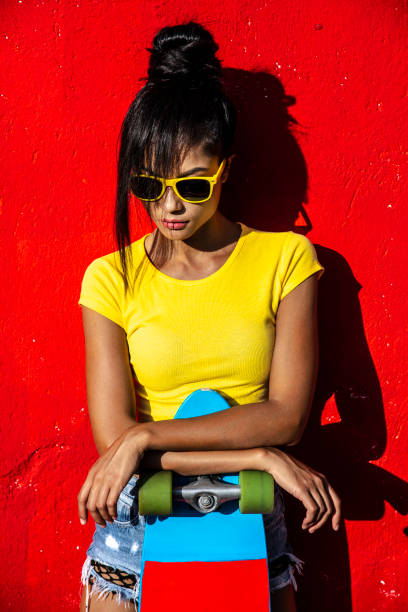 istock Beautiful asian woman leaning on skateboard 1028504690