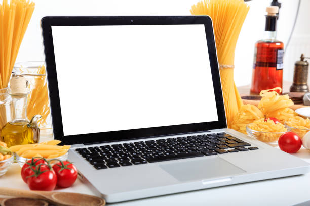 istock Laptop on a table with pasta and vegetables 1028504772