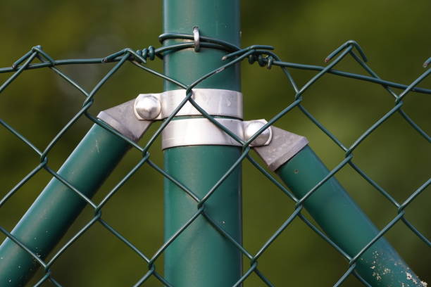 istock wire fence, green color, securing a site 1028507838