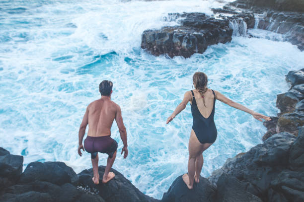 istock A millennial-age couple getting ready to jump into the ocean 1028512652