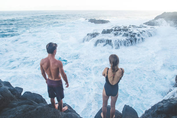 istock A millennial-age couple getting ready to jump into the ocean 1028512654