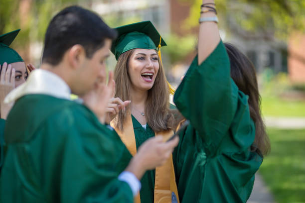 istock A multiethnic group of graduating students celebrate on the campus lawn 1028518024