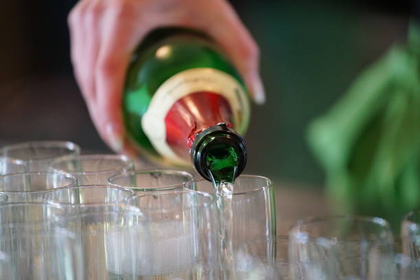 istock bottle of sparkling wine, poured in champagne cups 1028521380