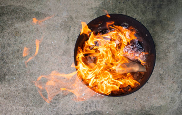 Close up paper burning in flame. Burning paper in the metal bin. stock photo