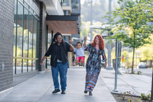 istock Female couple walking with their son 1028534588